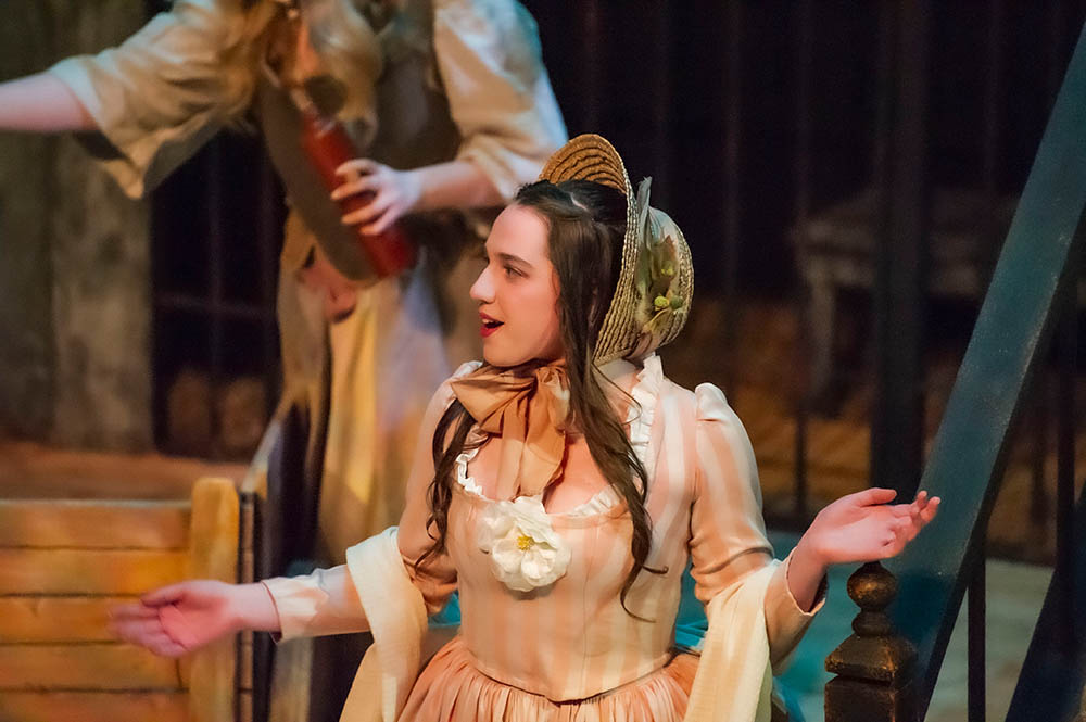 Female actor in profile wearing bonnet